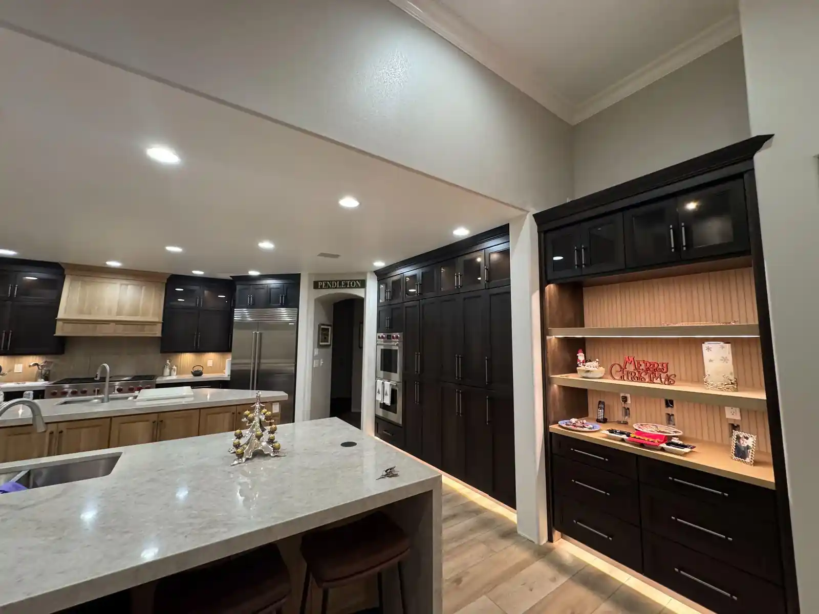 Custom cabinetry and illuminated built-in shelving