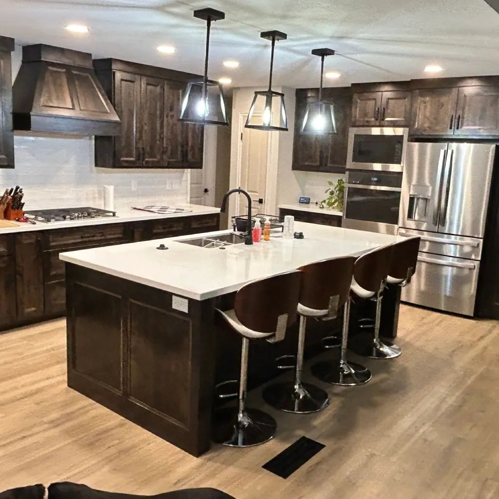 Modern kitchen with island and bar stools.