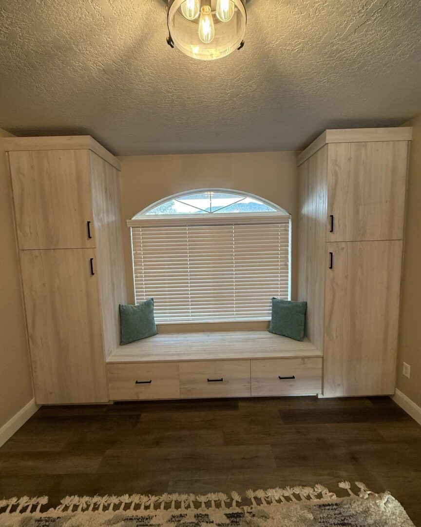 Built-in window seat with wooden cabinets.